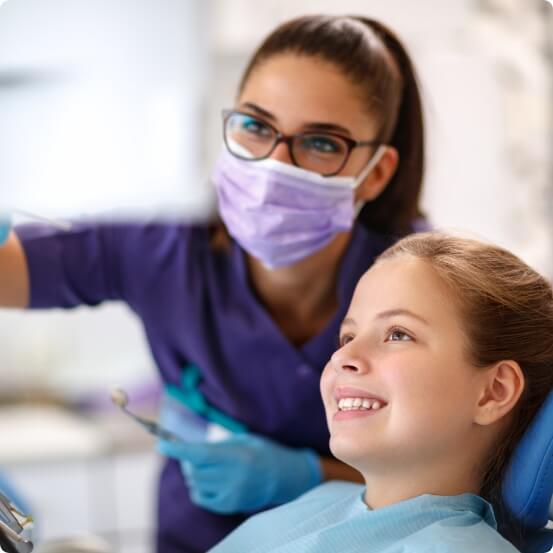 Dentist and young dental patient discussing dentistry treatment