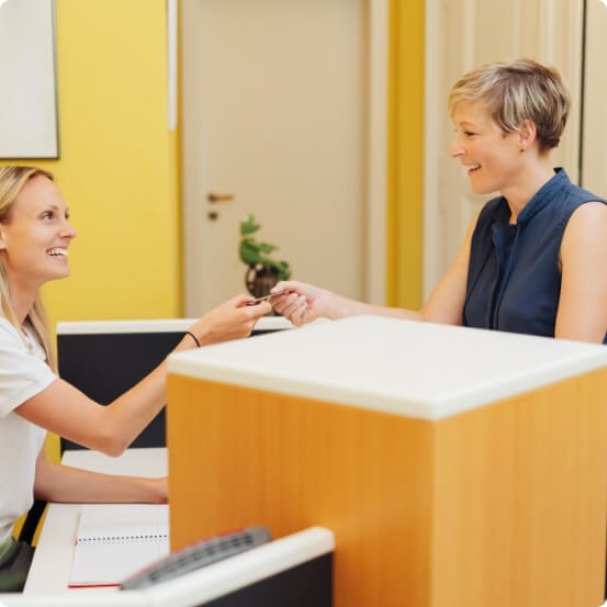 Friendly dental team member greeting dental patient