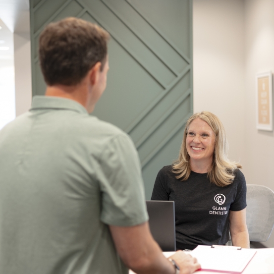 Friendly dental team member greeting dental patient