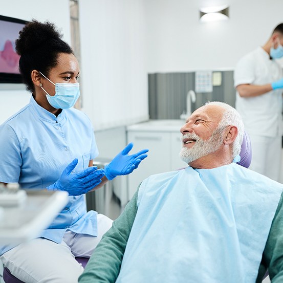 Man smiling at dentist during oral cancer screening