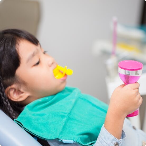 Child receiving fluoride treatment