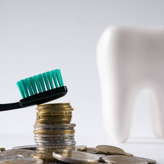 Toothbrush on a pile of coins