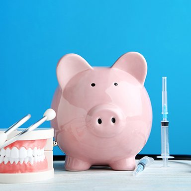 Piggy bank next to dental appliances