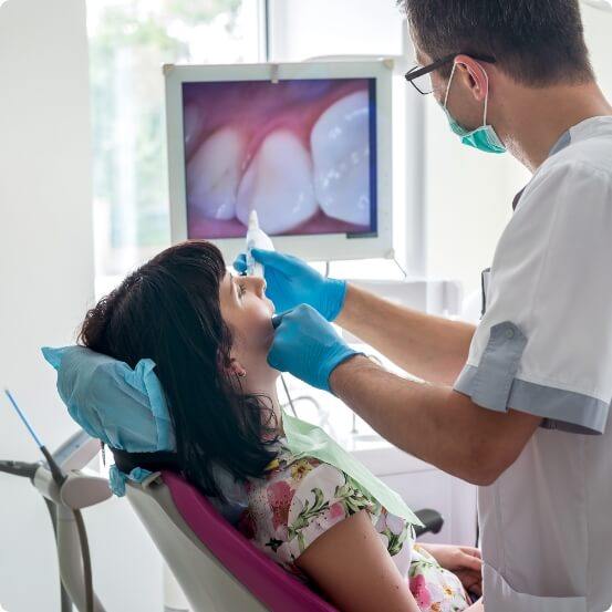 Dentist using intraoral camera to capture smile images