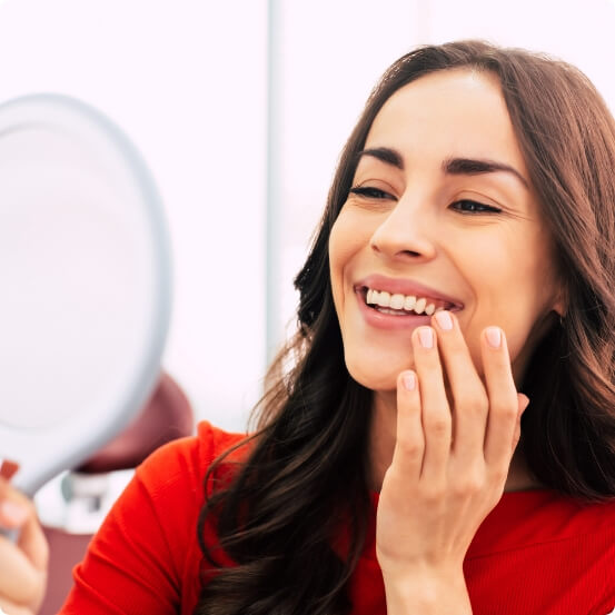 Smiling woman enjoying the benefits of dental implants