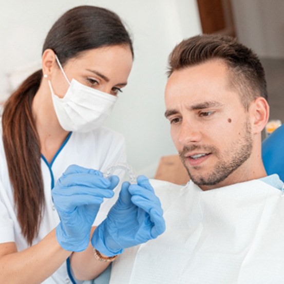 A dentist explaining how Invisalign in Columbus works