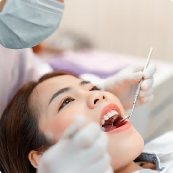 Dentist performing an oral cancer screening