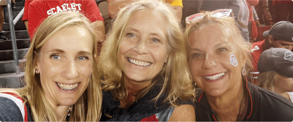 Three friends smiling during Ohio State game