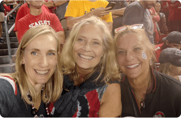 Three friends smiling during Ohio State game