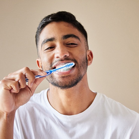 a man brushing his teeth