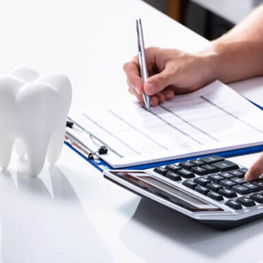 Patient in Columbus budgeting for teeth whitening treatment