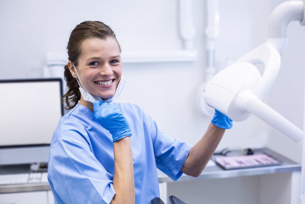 Dental hygienist smiling in treatment room