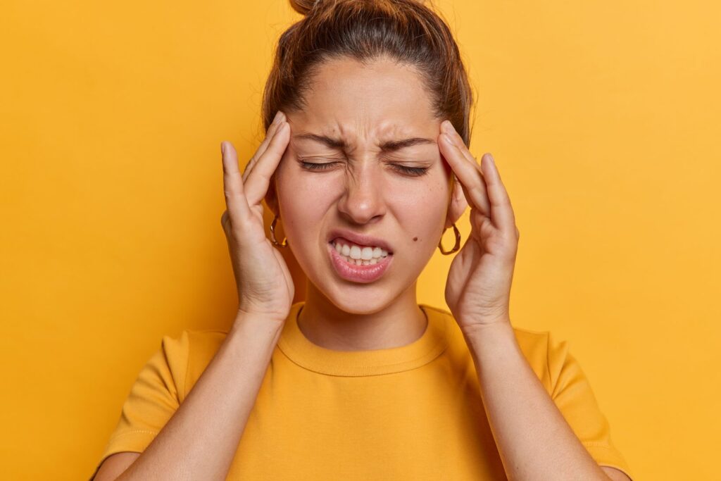 A woman grinding her teeth